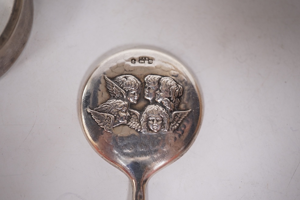 A late Victorian white metal and Scottish hardstone set 'X' brooch with coronet, 34mm, together with a silver hinged bangle and a George V silver mounted handbag mirror, with Reynold's Angels decoration. Condition - poor